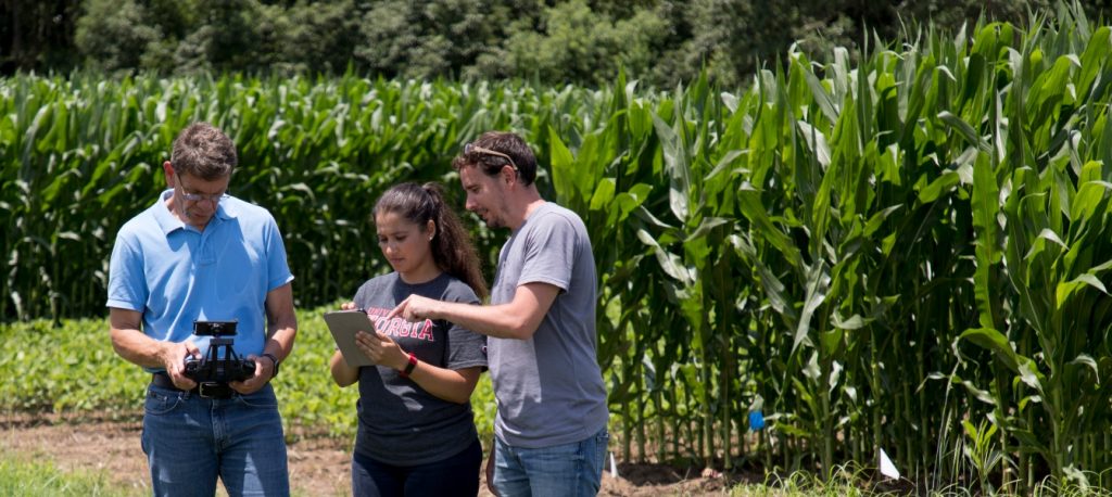 (L-R) Professor George Vellidis and graduate students Anna Orfanou and Dimitrios Pavlou prepare for takeoff with one of the drones that their research team uses for quick assessment of the health of their crops.